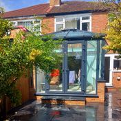 Anthracite grey small uPVC conservatory with French doors.